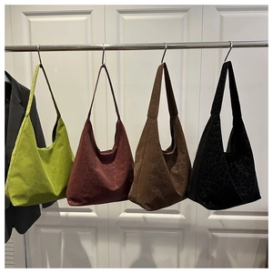 Detail view of four leopard pattern tote bags in green, burgundy, brown, and black