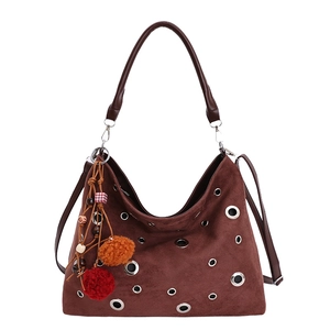 Brown suede hobo bucket bag with silver eyelets and boho tassel charm, main front view