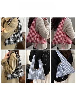 Detail view of plaid tote bag featuring side bow accents in black, red, and blue colors