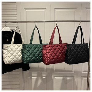 Detailed comparison of four quilted tote bags in white, green, burgundy, and black