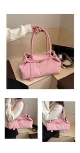 Close-up of pink corduroy tote bag with vertical texture and leather straps in a casual setting