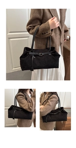 Detail of vintage black corduroy tote bag showing textured fabric and stylish shoulder strap