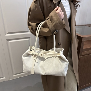 Minimalist beige corduroy tote bag with leather straps and buckle detail for women