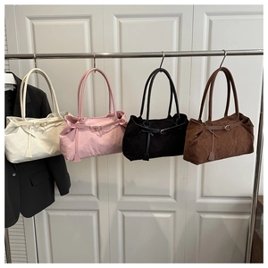 Detailed row of corduroy tote bags in cream, pink, black, and brown with slim straps