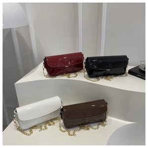Polished faux leather shoulder bags in red, black, white, and brown with gold chains