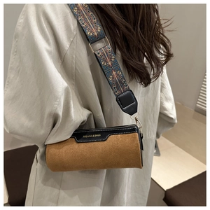 Brown cylindrical crossbody bag with vintage ethnic wide strap and fashion lettering