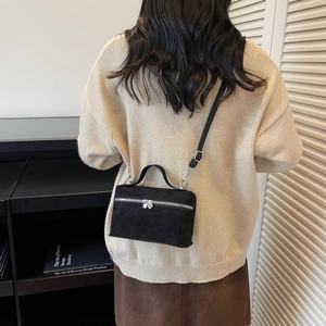 Modern black suede mini square crossbody bag with silver heart-shaped zippers