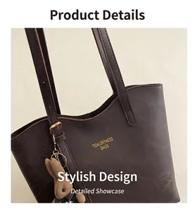 Detail of dark brown tote bag in cracked leather with gold logo and rabbit charm