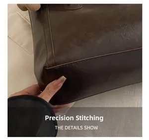 Detail showing precise stitching and smooth leather texture on the bag's corner