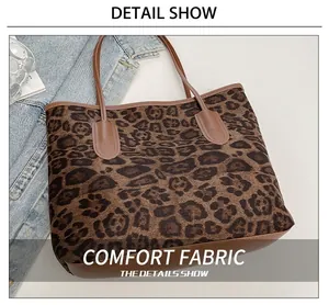 Close-up of leopard print tote bag with brown leather handles and soft textured fabric