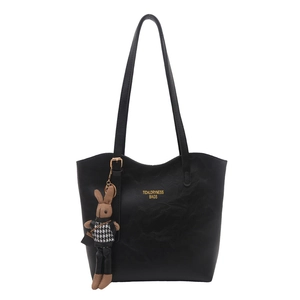 Large black textured leather tote bag for women with gold lettering and rabbit charm