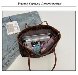 Interior view of leopard print tote bag showing capacity for iPad and essentials