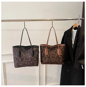 Detail view of large leopard print tote bags in grey and brown for fashion commuting