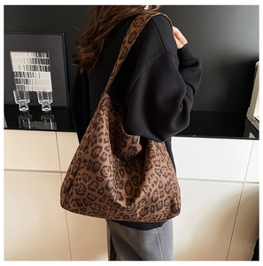 Leopard print tote bag shown on model with spacious design and soft textured fabric