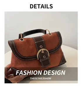 Close-up of retro color-block shoulder bag featuring brown suede and gold buckle detail