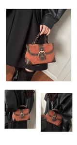 Detail view of retro suede and leather crossbody bag with vintage gold buckle and stitching