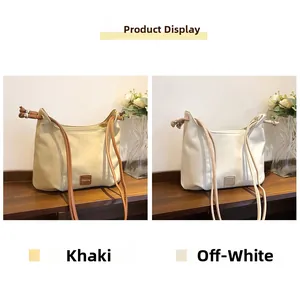 Minimalist PU leather shoulder bags in khaki and off-white colors on wooden shelf