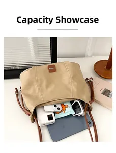Spacious khaki shoulder bag interior showing capacity for tablet, phone and accessories
