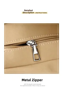 Close-up of premium silver metal zipper and smooth stitching on khaki leather bag