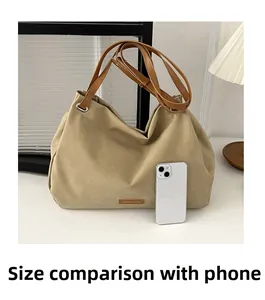 Size comparison of a khaki suede tote bag with a smartphone to show its large capacity