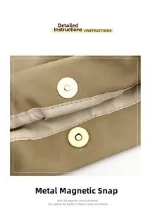 Detailed close-up of the high-quality magnetic metal clasp on the beige shoulder bag