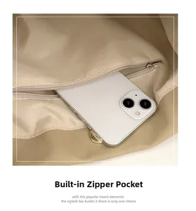 Detailed interior shot showing a built-in zipper pocket of the beige tote bag