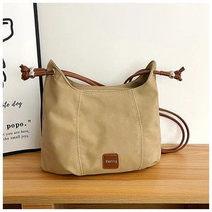 Detail of khaki nylon shoulder bag with brown strap and embossed Fashion leather patch