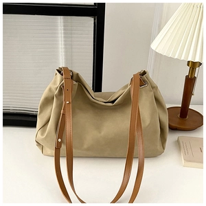 Detailed macro of the khaki hobo tote bag with premium brown leather straps and metal hardware
