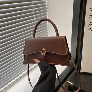 Classic dark brown trapezoid handbag with gold metal lock and elegant top handle