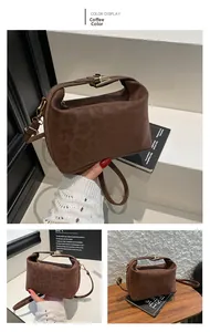 Detail of the coffee brown faux suede bag with leopard embossing and gold geometric lock