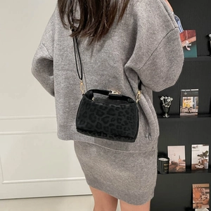 Fashionable leopard print shoulder bag with gold hardware and black leather strap