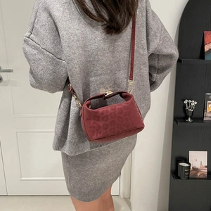 Burgundy leopard embossed crossbody bag with gold hardware and minimalist design