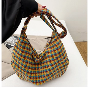 Detail of colorful plaid woven hobo bag showing thick texture and large capacity