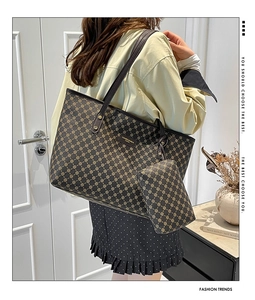 Brown geometric tote bag and matching coin purse set shown from a lifestyle side view