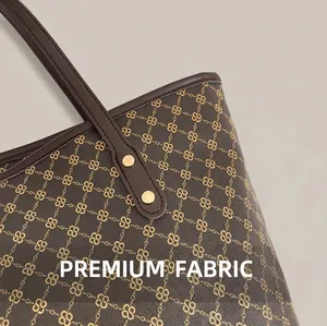 Detailed macro view of dark brown leather tote bag with gold S-pattern and rivet hardware