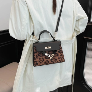 Leopard print crossbody bag with black glossy flap and classic metal lock closure