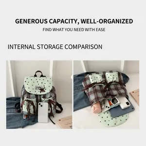 Detail view of plaid backpack interior capacity showing tablet and daily essentials