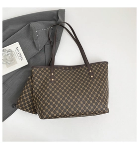 Brown monogram tote bag set with matching pouch next to Matisse art book