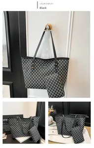 Detail of black tote bag with white geometric lattice pattern and metal logo plate