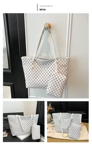 Macro detail of white geometric print tote bag set with matching small pouch and gold hardware