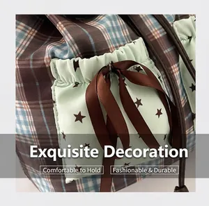 Detailed view of mint green side pocket with star print and brown satin ribbon bow