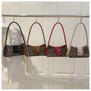Detail view of leopard print shoulder bags with decorative bows in four different colors