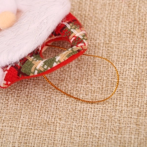 Macro shot of plaid fabric and plush fur trim on a Christmas gnome ornament detail