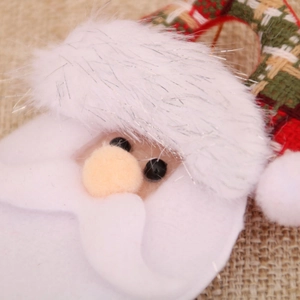 Detail of Santa Claus ornament with plaid fabric, faux fur beard and bead eyes