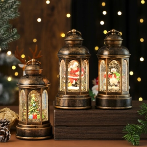 Close-up of vintage Christmas water lanterns with LED lights and swirling glitter snow