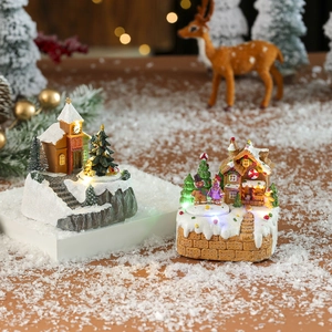 Village de Noël à LED avec église lumineuse et maison en pain d'épices sur neige