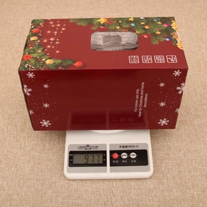 Christmas musical lantern box weighing 977g on scale with LED and USB features