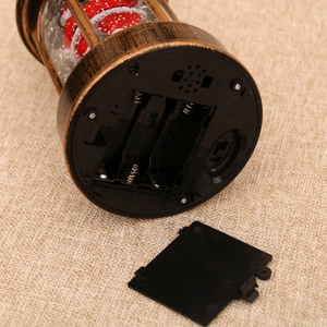 Detail view of the vintage Christmas lantern base with battery compartment and power switch