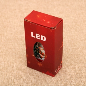 Detailed view of red Christmas LED lantern packaging with gold snowflakes and SPU window