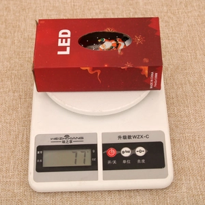 Detailed view of red Christmas lantern packaging showing dimensions 74x42x139mm and 77g weight
